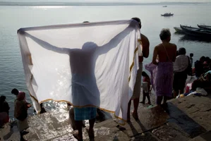 color travel street photo of man in Ganges, India by Margo Ryan