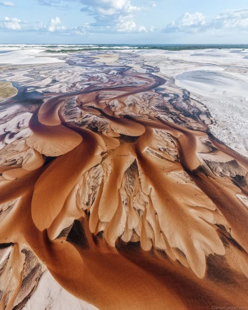 color aerial landscape photo of sediment in river by Daniel Kordan