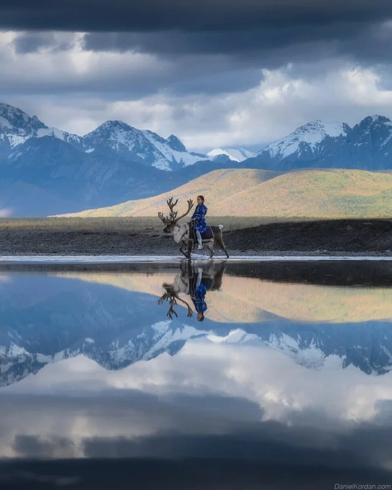 color landscape and portrait photo of woman riding reindeer by Daniel Kordan