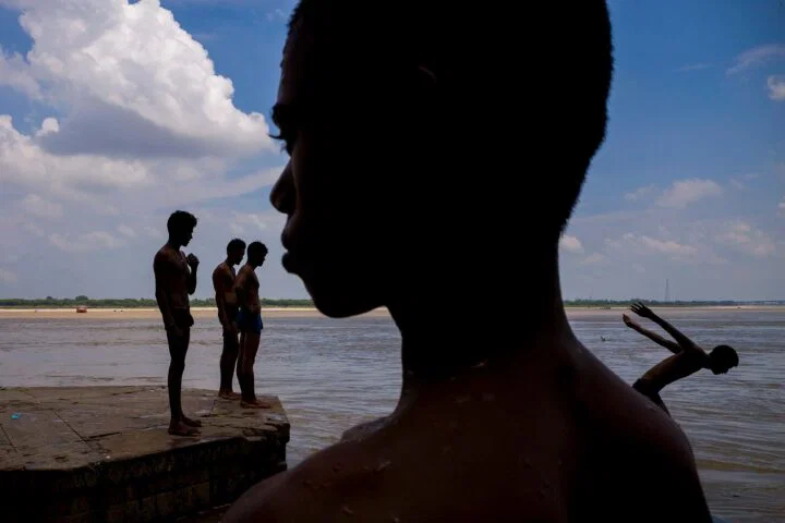 color street photo of children swimming in India by Vineet Vohra