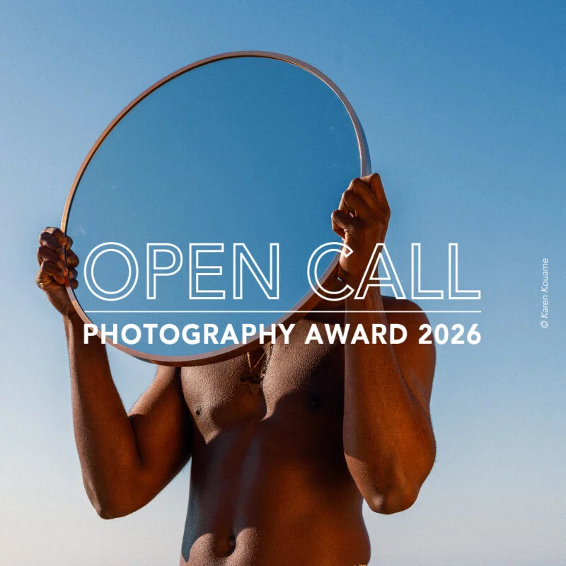 Color fine art portrait photo of man holding mirror by Karen Kouame. Open Call Award