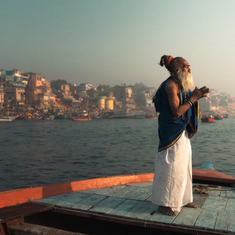 Color travel photo of Sadhu praying in Varanasi, India by Earl Martin