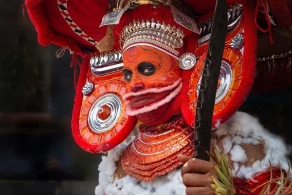 Color travel portrait photo of a Theyyam performer in northern Kerala, India by Erika Howard