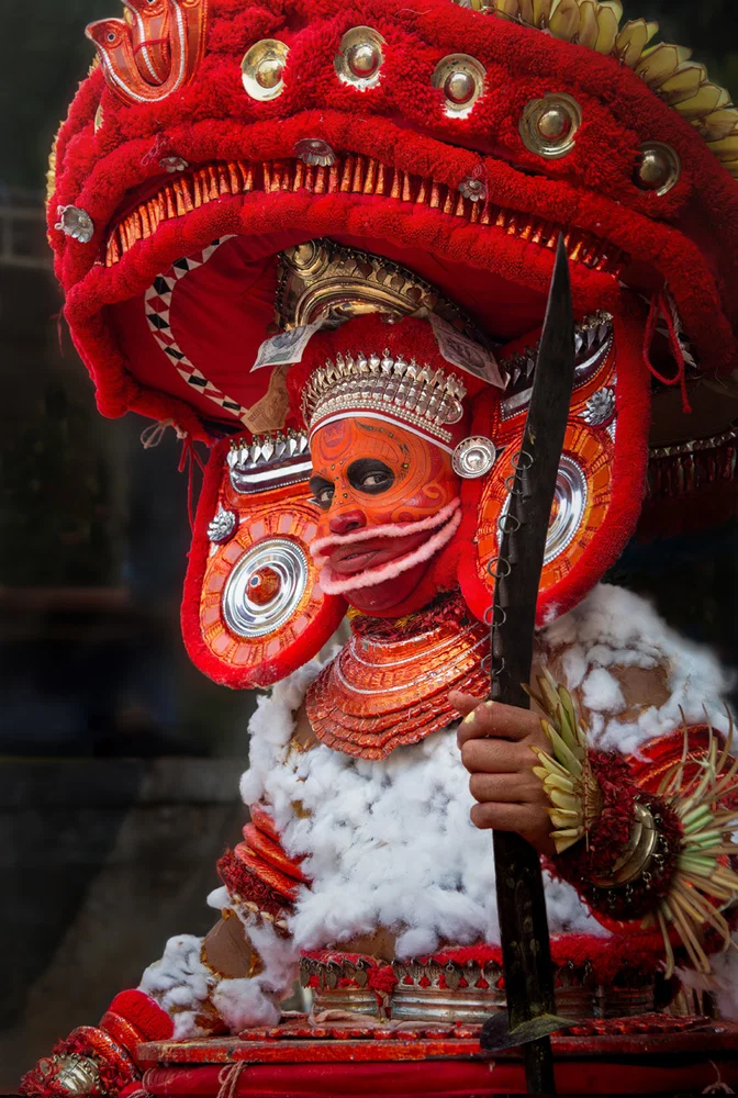 Color travel portrait photo of a Theyyam performer in northern Kerala, India by Erika Howard