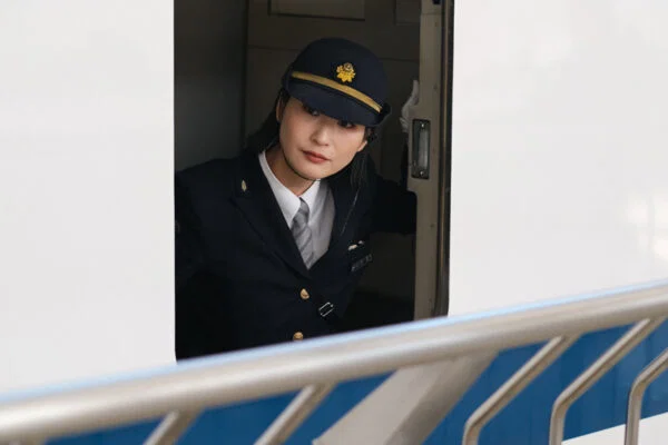 Color travel portrait photo of female train driver in Kyoto, Japan by Joe Keating