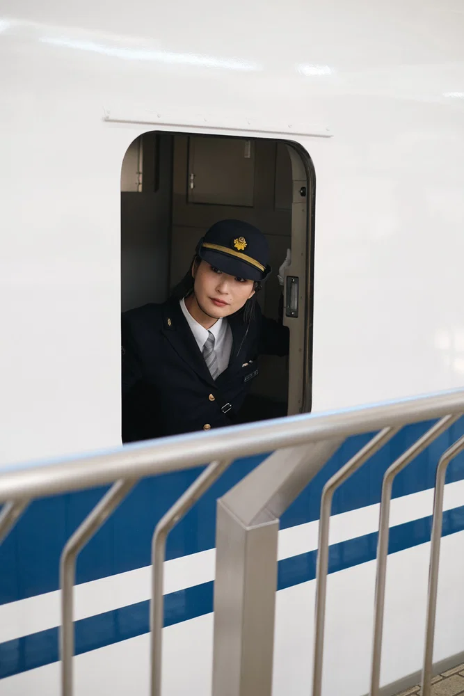 Color travel portrait photo of female train driver in Kyoto, Japan by Joe Keating