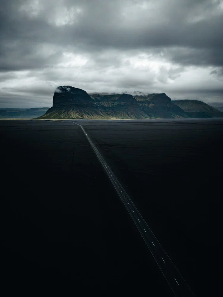 Color landscape photo of road and black sand in Iceland by Maria Lungu