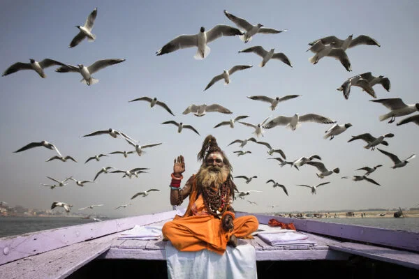 Color travel photo of Sadhu and Seagulls in Varanasi, India by Neşe Ari