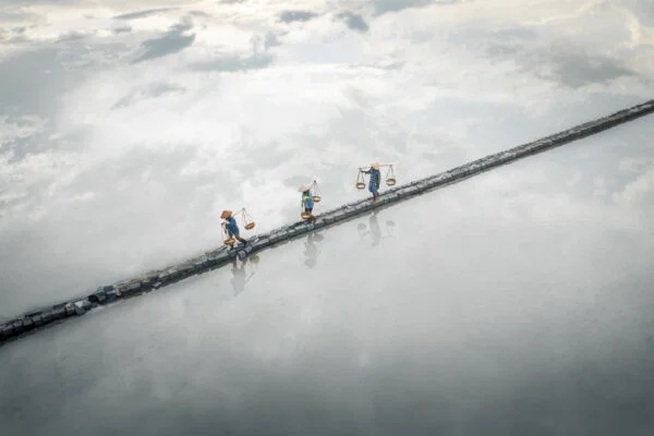 Color travel photo of salt harvester in Vietnam by Thea Mihu