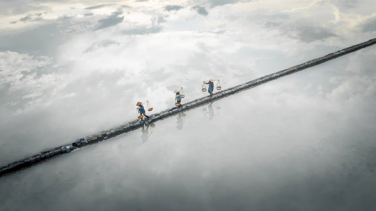 Color travel photo of salt harvester in Vietnam by Thea Mihu