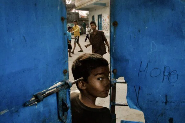 Color street photography of children playing in Kolkota, India by Sumitro Banerjee