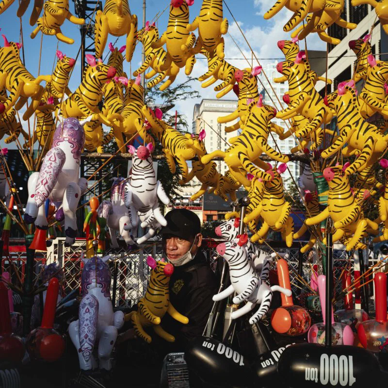 Color street photography of man with toy in Vietnam by Nicola Balestrazzi